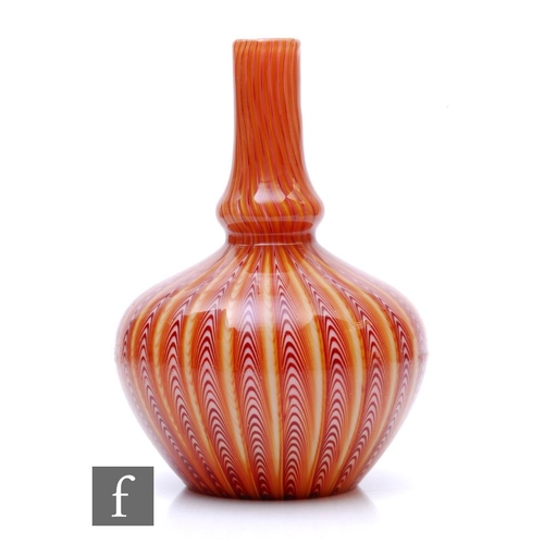 A late 19th Century Stevens and Williams Osiris glass vase of globe and shaft form with compressed ovoid base rising to a tall flared neck cased in clear crystal over a tonal red to amber pulled ground with pink interior, height 19.5cm.