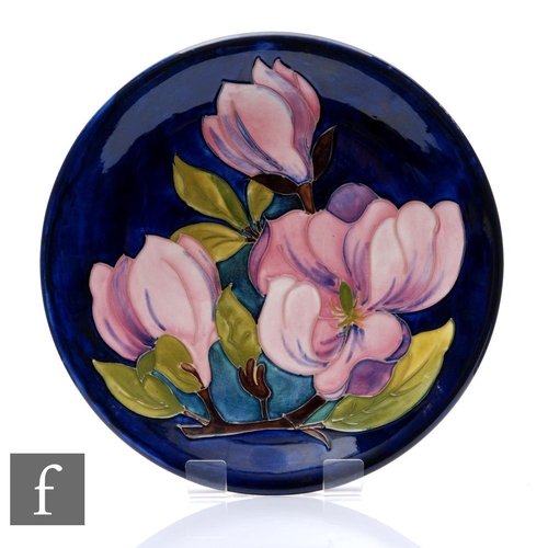 105 - Moorcroft Pottery - A plate of circular form, shape 783/10, decorated in the Magnolias pattern with ... 