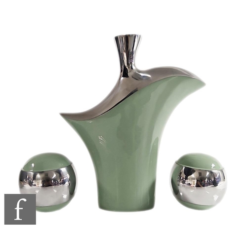 1131 - Unknown - A contemporary bright metal vase of abstract form, decorated with pale green enamel, heigh... 