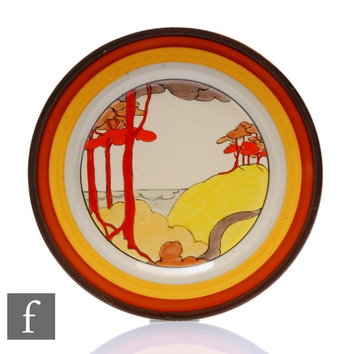 165 - Clarice Cliff - Coral Firs - A large circular plate circa 1933, hand painted with a stylised tree li... 