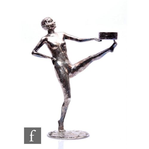 526 - R. Martin - An early 20th Century French silvered Art Deco figure study of a female nude with leg ra... 