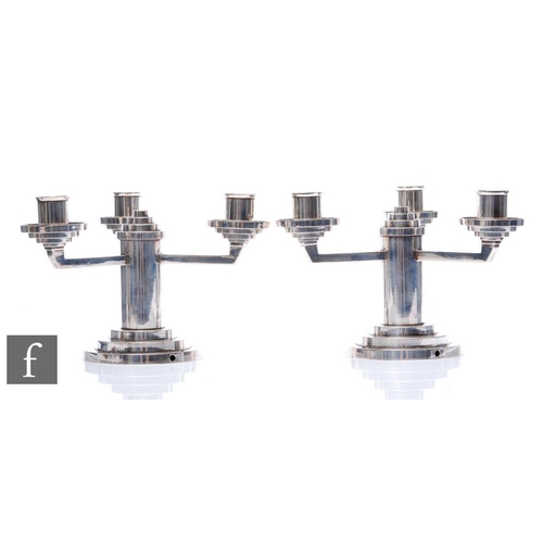 532 - H. Mourier - A pair of Art Deco silver plated candelabra, the stepped circular base, rising to a cen... 