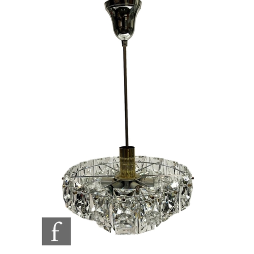 701 - Kinkeldy - A German 1960s/70s crystal prism four-tier chandelier light fitting, with central gilt me... 