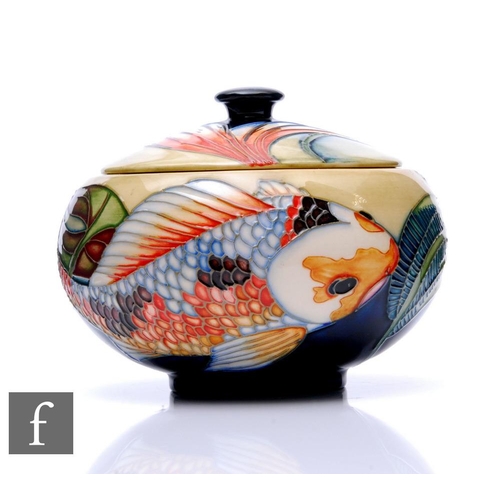 88 - Philip Gibson - Moorcroft Pottery - A lidded bowl of squat ovoid form, shape 147/5, decorated in the... 