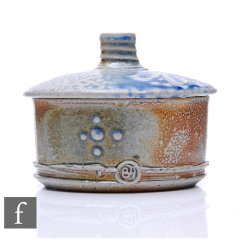 1091 - Barry Huggett - A contemporary studio stoneware lidded box of cylinder form, decorated with relief a... 