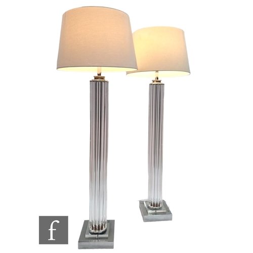 1170 - Eichholtz - A pair of Art Deco style torchere style floor lights, the square plinth chrome base risi... 