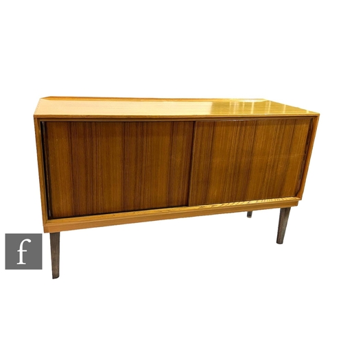 730 - Gordon Russell Furniture - A walnut and Bombay rosewood sideboard, with sliding double doors above t... 