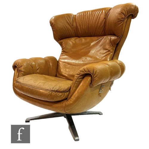 778 - Overman - Sweden - A 1970s tan vinyl upholstered swivel armchair on aluminium base, unlabelled.NB - ... 