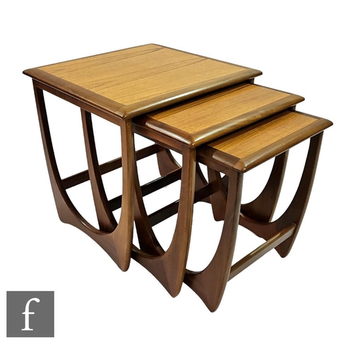 729 - Victor B. Wilkins - G-Plan Furniture - A nest of three teak model 8041 occasional tables, with loop ... 