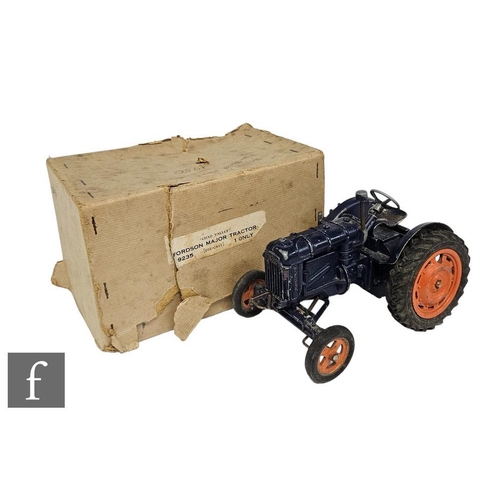 A Chad Valley 9235 Fordson Major Tractor, blue with dull orange wheels and black tyres, in damaged buff lift off lid box with black and white paper label to side.