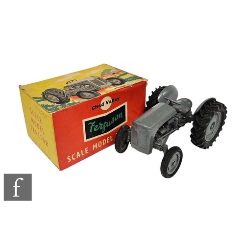 A Chad Valley Ferguson Tractor, in grey including wheels with black tyres, with inner packing piece in picture box.