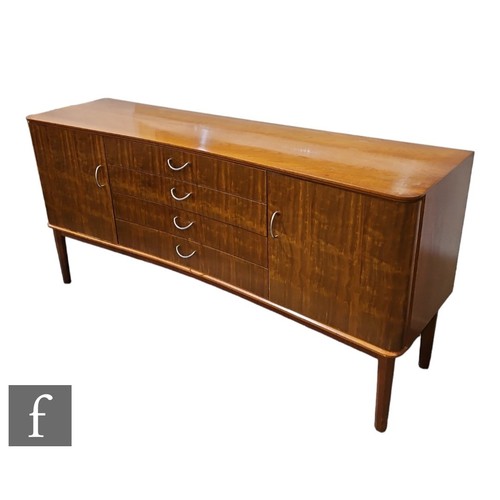 588 - A 1960s composed teak and Indian laurel dining suite by W.H Russell for Gordon Russell Furniture Ltd... 