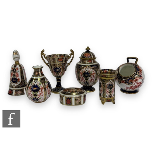 111 - A small collection of 20th Century Royal Crown Derby porcelain items to comprise a table bell, oval ... 