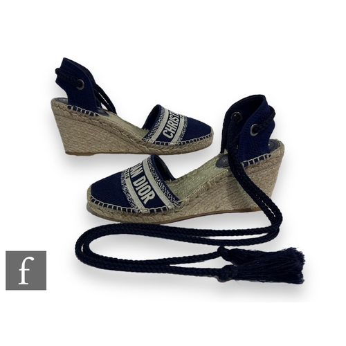 185 - A pair of Christian Dior Granville embroidered cotton wedge espadrille sandals, decorated with a lar... 