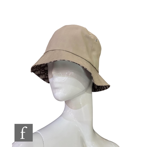 186 - A Christian Dior reversible Teddy-D small brim bucket hat, in a reversible camel cotton mix fabric a... 