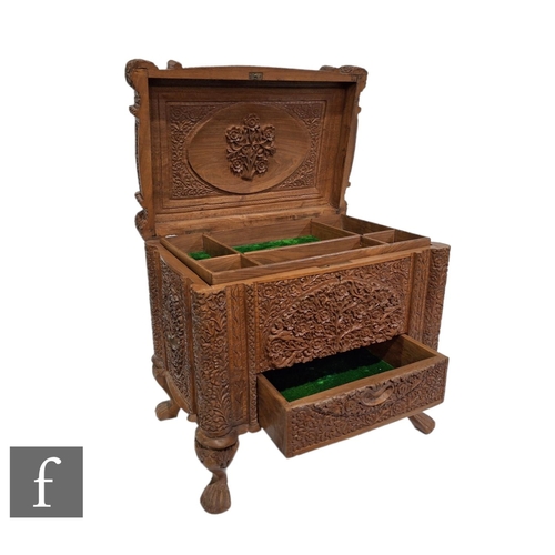 5 - A 20th Century Bombay carved hardwood chest cabinet, detailed floral panels, fitted with an interior... 