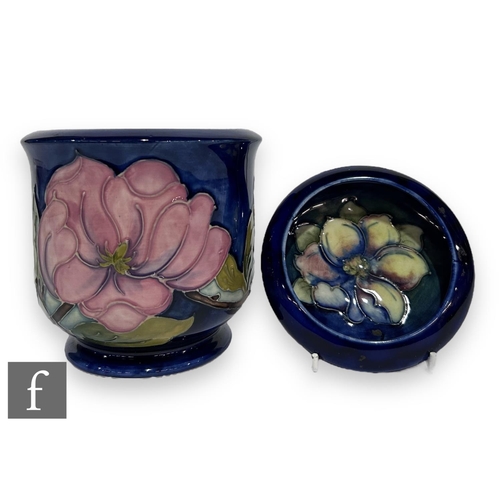 57 - A post war Moorcroft Pottery jardinière of footed cylindrical form with roll rim, tube line decorate... 