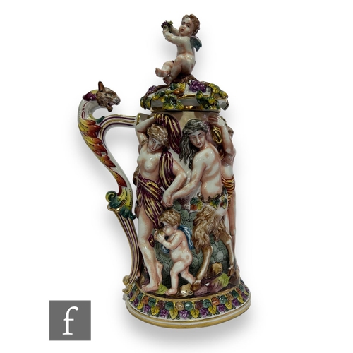 75 - A large 20th Century Italian Capodimonte tankard and cover, heavily relief moulded with a Bacchanali... 