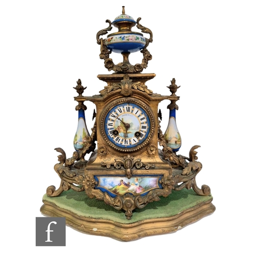 366 - A 19th Century French gilt mantle clock surmounted with an urn over baluster side mounts and Sevres ... 