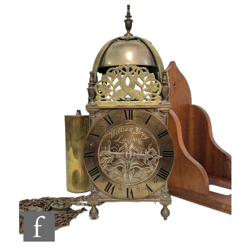 368 - A 17th Century style brass lantern clock with chain driven movement with single weight below a bell ... 