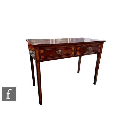 564 - A George III inlaid mahogany two drawer side table, the rectangular top decorated with an urn patera... 