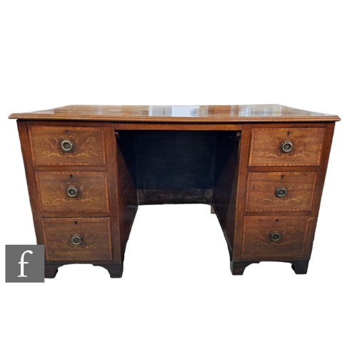 567 - An Edwardian Sheraton style marquetry inlaid kneehole dressing table, the satinwood crossbanded top ... 