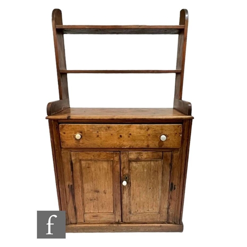 579 - A small Victorian stained pine dresser and rack, single drawer over a cupboard plinth base, height 1... 