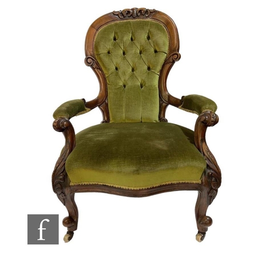 605 - A Victorian carved walnut open arm easy chair upholstered in pale green buttoned plush, on cabriole ... 