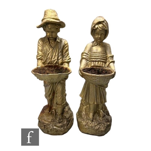 622 - A pair of early 20th Century cast iron garden fountain figures of a Dutch boy and girl, each holding... 