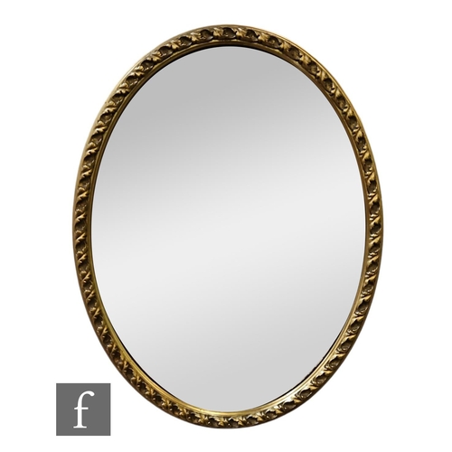 568 - A 20th Century replica gilt bevelled edge wall mirror, deep moulded edge scroll frame, 79cm x 68cm, ... 