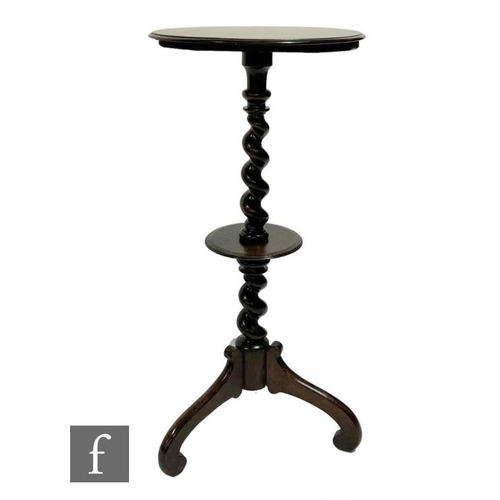 570 - A 19th Century circular rosewood lamp table or torchere stand, spiral twist column with small under-... 