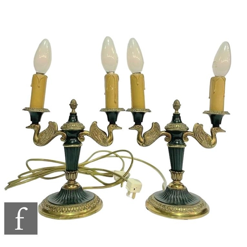 371 - A pair of post 1950s French Empire style double sconce gilt table lamps, the branches modelled as wi... 