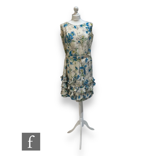 221 - A 1950s/60s lady's vintage sleeveless dress with large blue stylised flowers over a cream ground wit... 