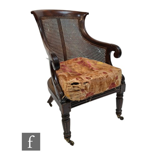 598 - A 19th Century mahogany bergere cane library chair in the manner of Gillows, the shaped bar back ove... 