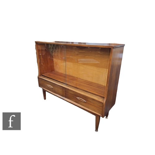 625 - A 1960s teak bookcase with sliding glazed double doors, over two drawers and tapered legs, unlabelle... 