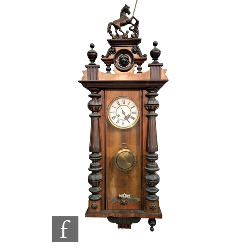 390 - A 19th Century walnut cased Vienna wall clock the circular dial and spring driven movement enclosed ... 