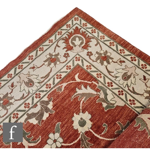 628 - A large Caucasian carpet all over floral decoration on an ivory and rust coloured ground, length 400... 