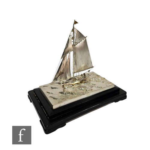 374 - A silver study of a yacht, stamped silver 970, cast with single masted yacht on rough waters,  25cm ... 