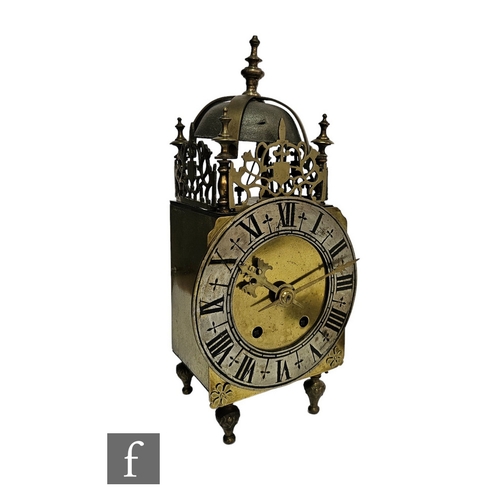 386 - A late 19th to early 20th Century brass lantern clock, the bell canopy above a pierced gallery and a... 