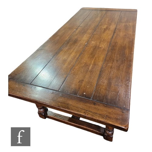 591 - A 17th Century style oak refectory dining table, the plank top over a plain frieze on turned legs un... 