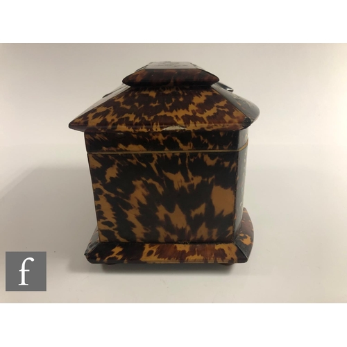 373 - An early 19th Century Regency tortoiseshell tea caddy of inverted breakfront form, inlaid with white... 