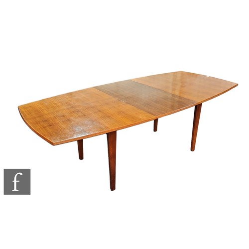 588 - A 1960s composed teak and Indian laurel dining suite by W.H Russell for Gordon Russell Furniture Ltd... 