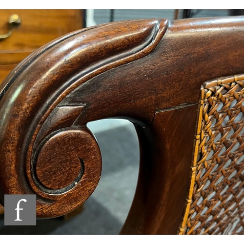 598 - A 19th Century mahogany bergere cane library chair in the manner of Gillows, the shaped bar back ove... 