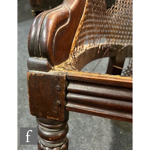 598 - A 19th Century mahogany bergere cane library chair in the manner of Gillows, the shaped bar back ove... 