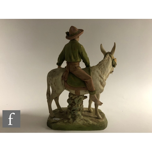 102 - A large late 19th to early 20th Century Royal Dux figure group modelled as a young boy riding a donk... 