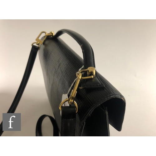 211 - A 1990s Louis Vuitton black Epi leather Monceau crossbody bag, with front pocket, embossed logo at f... 