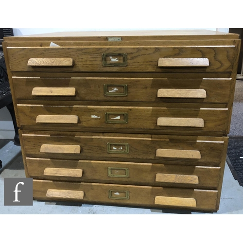 577 - A 1930s light oak plan chest, the 'Arclight', in two sections, maker's tablet by N Mason and Sons Li... 