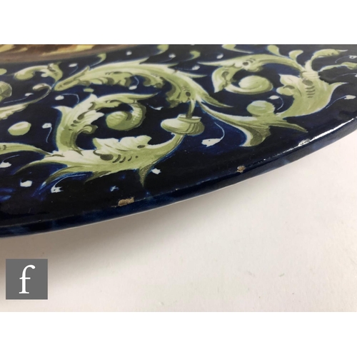 72 - A near pair of 19th Century Italian Faience Ware charger in the manner of Cantagalli, each decorated... 