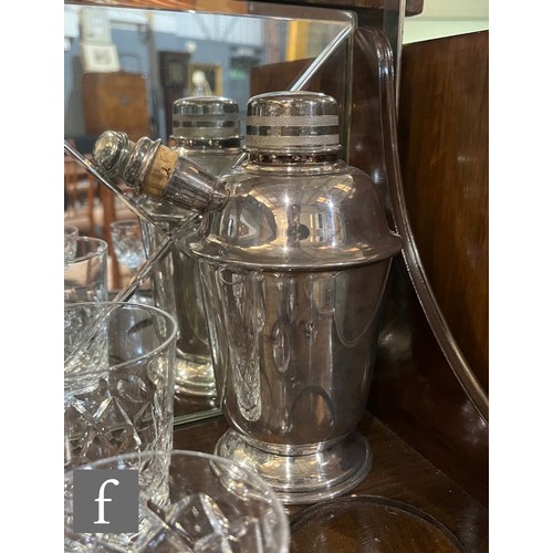 610 - A late 1940s burr walnut cocktail cabinet complete with drinking glasses, a plated cocktail shaker a... 