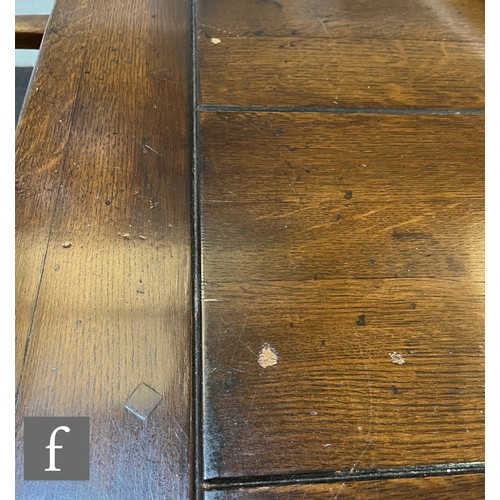 591 - A 17th Century style oak refectory dining table, the plank top over a plain frieze on turned legs un... 